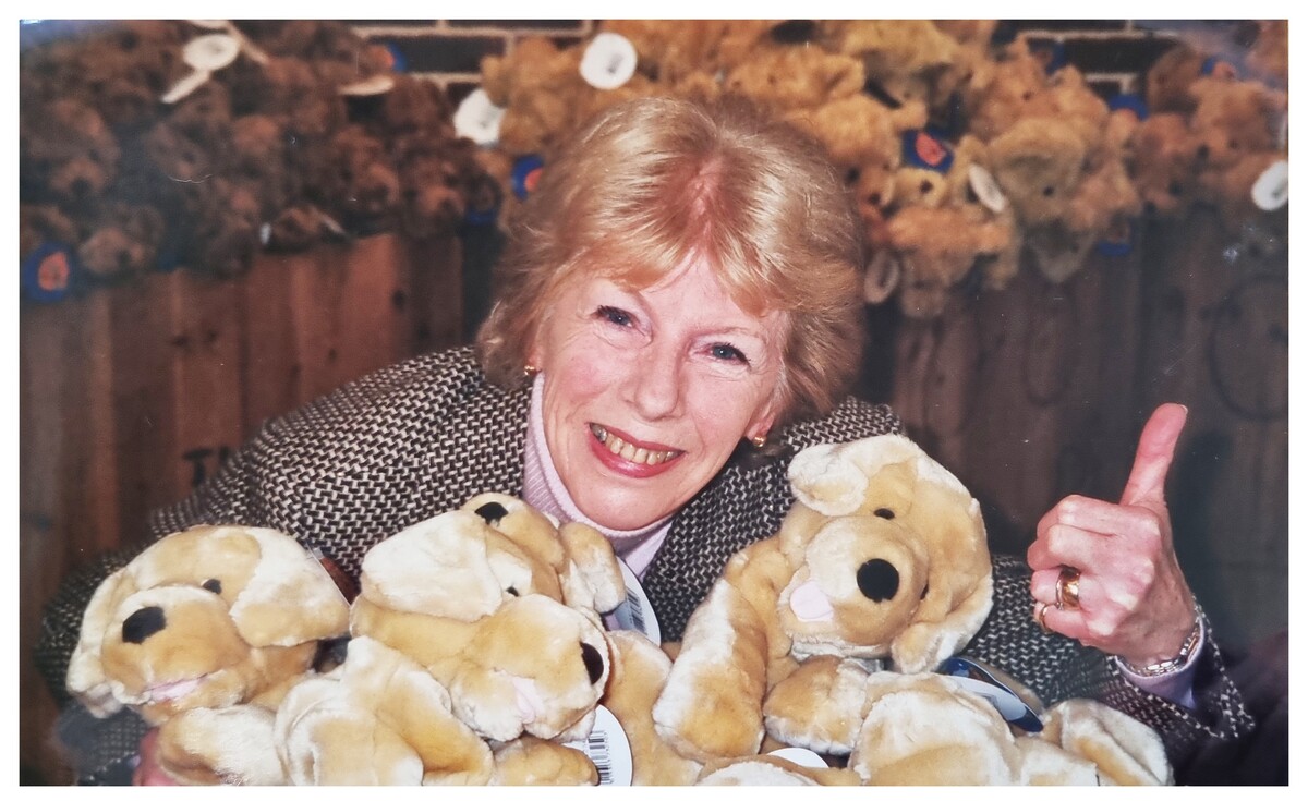 Pat Spence posing with soft toys!